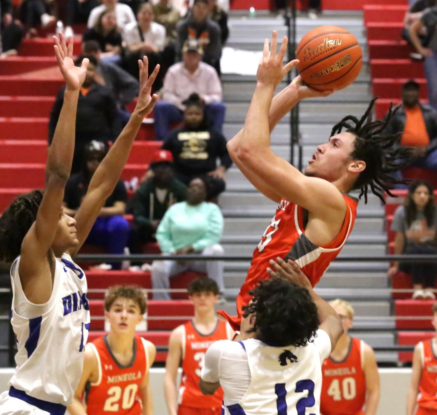 Mineola’s Braydon Alley puts up a jumper from the lane.
